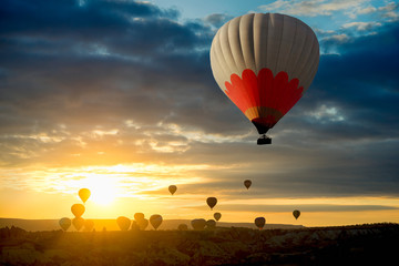 Panoramic view of the Hot Air balloons flying tour over Mountains landscape spring sunrice Cappadocia, Goreme Open Air Museum National Park, Turkey nature background.