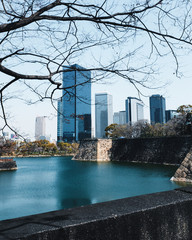 The Wall around Osaka Castle with the view to a modern building
