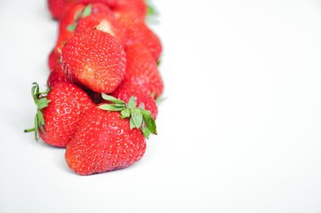 Red strawberries on a white background. Red berries. Berries for the cake. Strawberry basket. A group of berries. Fresh fruit and juicy fruit for fruit drink.
