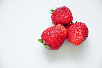 Red strawberries on a white background. Red berries. Berries for the cake. Strawberry basket. A group of berries. Fresh fruit and juicy fruit for fruit drink.