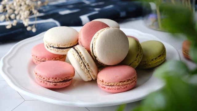 Colorful French macarons cakes desert set on party table.