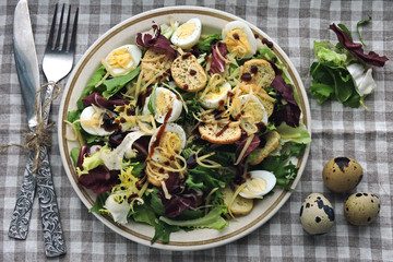 Keto diet. Nutritious salad with quail eggs, cheese and mix salad.