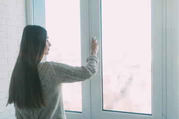 Young woman opening new modern window, closeup view