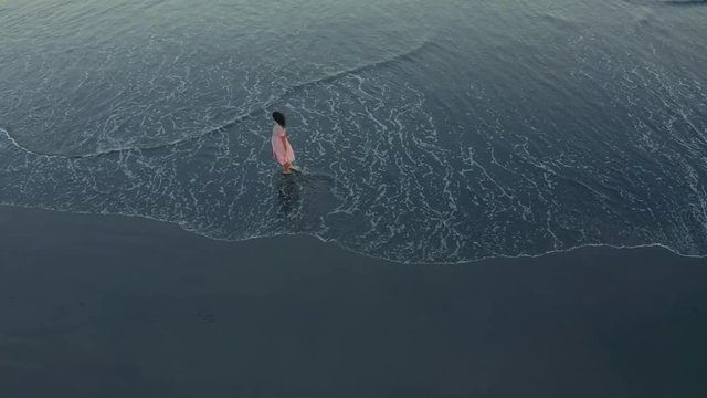 She loves the Evening Rush Playing with Her Teet. Slim and Tanned Brunette Walking along the seashore to the Washed Wave. Aerial view Walking and Spinning at the Ocean Girl. Drone shot 4K