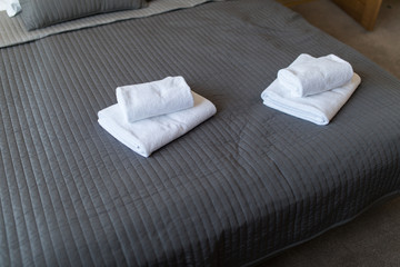 Fototapeta na wymiar White towel on bed decoration interior of bedroom.