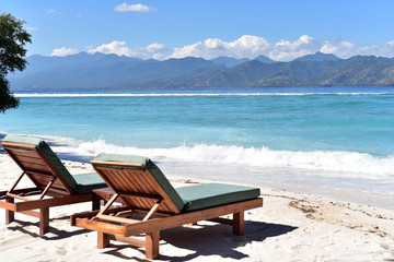 Sun loungers or deckchairs on a sandy beach with ocean view, Gili Trawangan Island, Indonesia