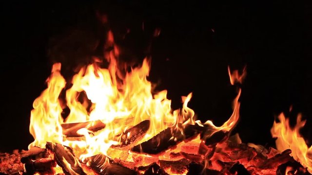 Home style footage. No sound. Twenty nine 29 seconds of bonfire or campfire for Guy Fawkes theme by a body of water at dusk. Relaxing and romantic