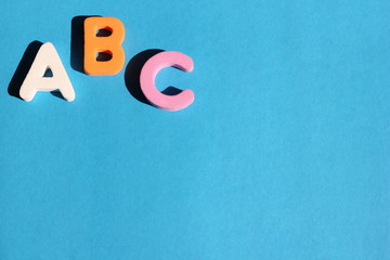 ABC first letter of the English alphabet on a blue background. Empty space for text. Learning foreign language. English for beginners.