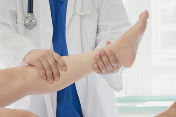 Doctor giving a patient a leg treatment