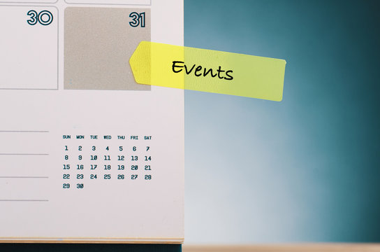 Time planning concept, word EVENTS written on yellow sticky paper and calendar over beautiful reverberation gradient background