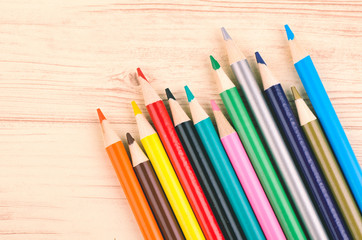 close-up image of Colourful pencils on wooden desk