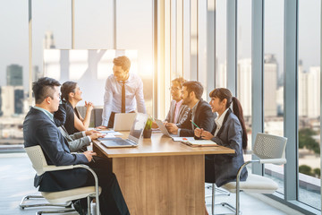 Businesspeople discussing together in conference room during meeting at office.