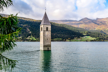 Tower of ancient submerged church on the lake di Resia, Italy