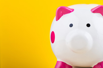 close-up image of white piggy bank over yellow background for saving concept - 263148362
