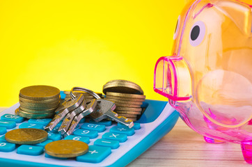 empty piggy bank, stacking coin with bunch of key on calculator for financial and saving concept