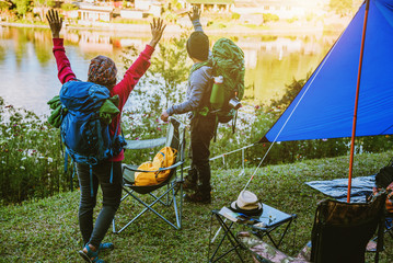 Asian couple Mountain camps in rural villages, close to the lake, travel ideas, camping, relaxing holidays.in Thailand