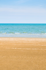 Fototapeta na wymiar Abstract beach background. Yellow sand, blue sky