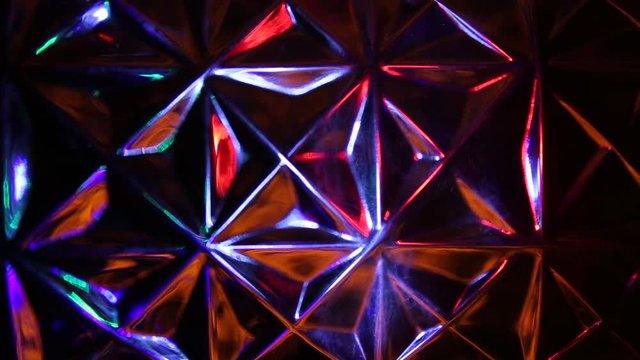 Transfusion of multi-colored light rays on a background of triangles