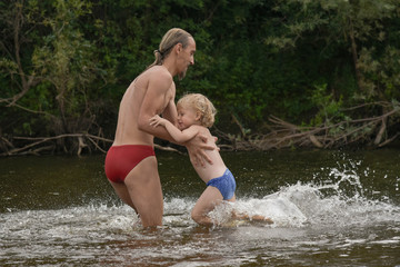 father teaching his little son to swim, they are happy.vacation. family, summer time, beach.