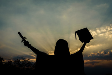 Female university graduate celebrates graduation ceremony receiving degree certificate happily with excitement.