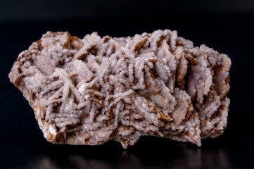 Macro stone mineral gypsum with calcite on black background