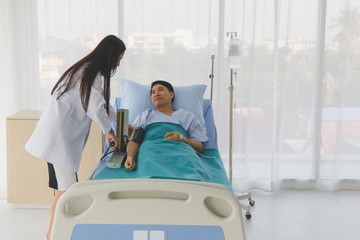 Doctor check patient's blood pressure in hospital.