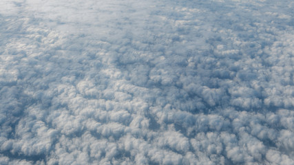 The beautiful cloudscape with clear blue sky. A view from airplane window.