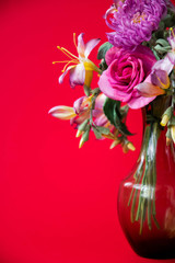 beautiful artificial flowers on red background. Art soft focus