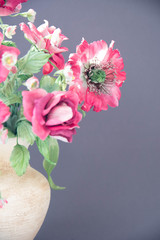 beautiful artificial flowers on grey background. Art soft focus