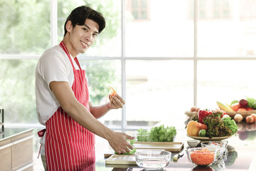 Asian man are preparing a salad plate..