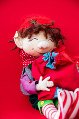 toy rag doll on red background. Art soft focus