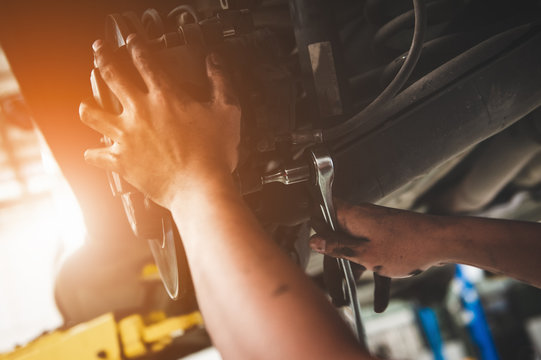  Mechanic repairing a car with replace brake disc and pads