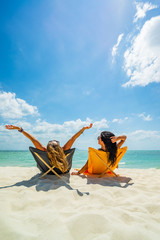 Woman enjoying her holidays on a transat at the tropical beach