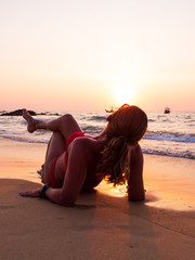 young woman on the sea at sunset
