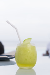 Guava frappe juice in glass on wood table.