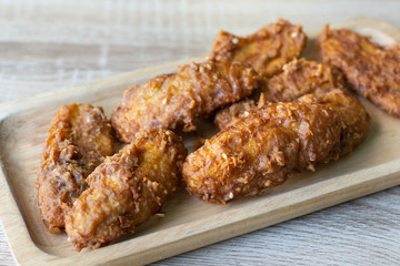 Deep fried banana in wooden dish on table.