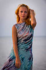 Young red woman on a beach