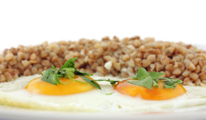 Fried Eggs with buckwheat porridge in plate