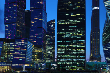 Moscow/ Russia April 19 2019: The windows of the unique skyscrapers of Moscow city, the modern office center in Moscow in the evening in the rays of setting sun on the bank of Moskva river