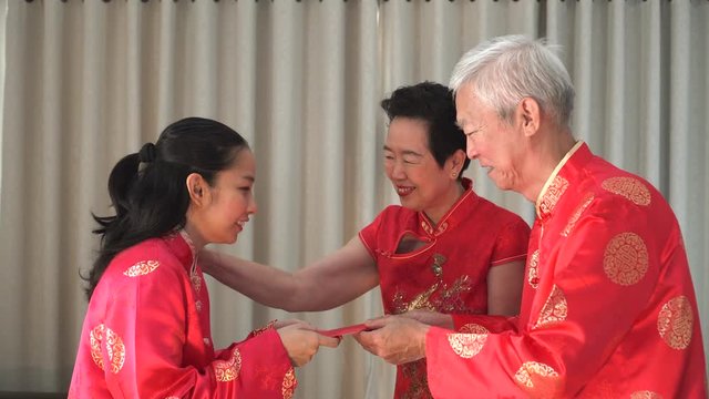 Asian parents give gold bracelet for chinese new year present to daughter