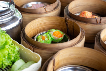 Dim sum stuffed crab in tray on wooden table.