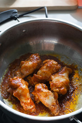 Spicy drumstick or Fried chicken with tomato sauce and black pepper in bowl.