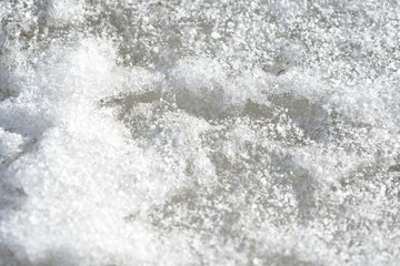 Abstract snow texture. Early spring snow background close up