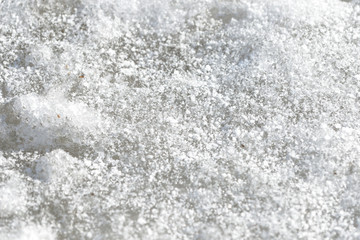 Abstract snow texture. Early spring snow background close up