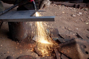 Hand of man / industrial worker use angle grinder to cut metal or steel