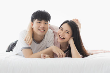 Fototapeta na wymiar Asian couple spending time together on the bed..