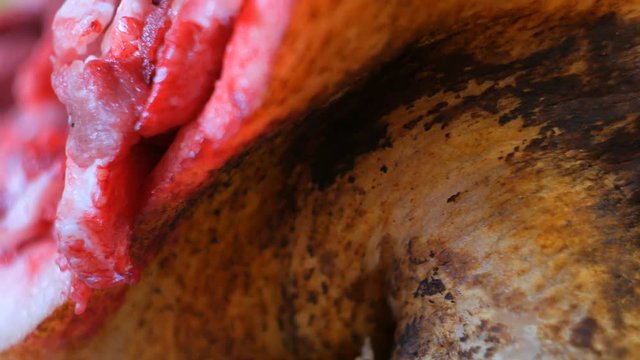 Bizarre pig head Circling on a table. Close-up. Pig heads being sold at the market.