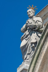 Fototapeta na wymiar Decorative facade sculptures at Jesuit church of St. Ignatius of Loyola at Charles Square in Prague, Czech Republic