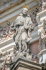 Fototapeta na wymiar Decorative facade sculptures at Jesuit church of St. Ignatius of Loyola at Charles Square in Prague, Czech Republic