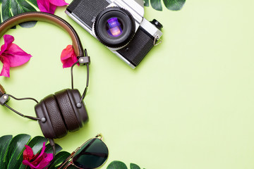 green background with camera headphones and glasses tropical theme